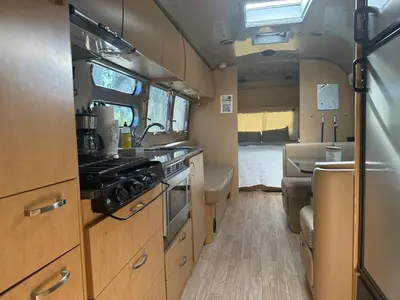 a kitchen in an rv with a sink and a stove at Airstream at Tree Ranch Grove Paradise in Ojai