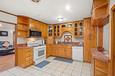 a large kitchen with wooden cabinets and white appliances at Fireplace Evenings • Smart TV • Sleeps 7 in Carson