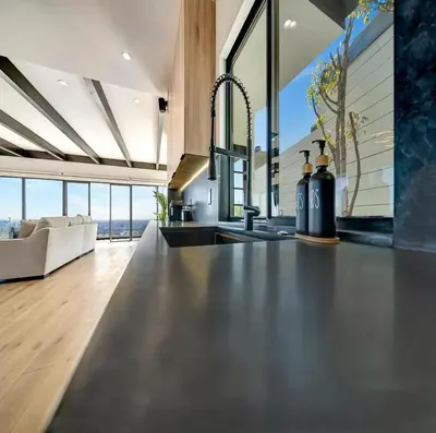 a kitchen with a counter top and a living room at Skyview Estate in Los Angeles