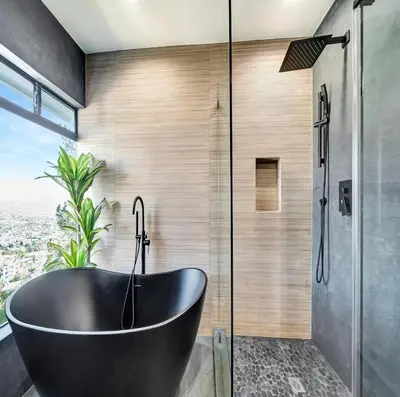 a black bath tub in a bathroom with a window at Skyview Estate in Los Angeles