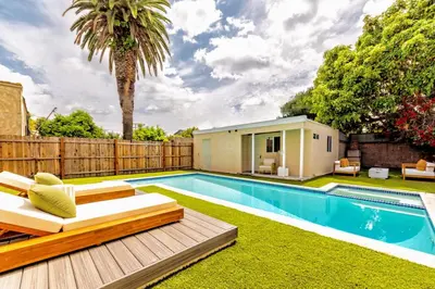 a swimming pool in a backyard with a wooden fence at Relaxing 4BR LA Home Private Pool & Fire Pit in Los Angeles