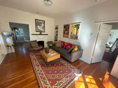 a living room with a couch and a coffee table at Charming Boho Pasadena Cottage Near Rose Bowl in Pasadena