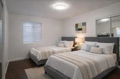 a bedroom with two beds and a window at Irolo Guesthouse in Los Angeles