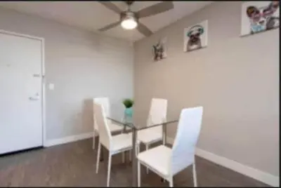 a dining room with a glass table and white chairs at Polished 1BR Hollywood Apt w Rooftop Pool & Views in Los Angeles