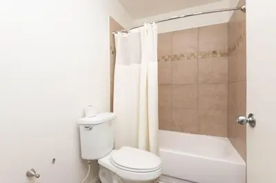 a bathroom with a toilet and a tub and a shower at Polished 1BR Hollywood Apt w Rooftop Pool & Views in Los Angeles