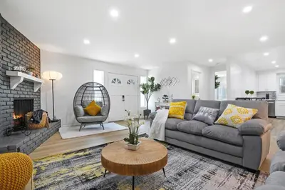 a living room with a couch and a fireplace at Walk to Shoreline Village, BBQ in Prime Location in Long Beach