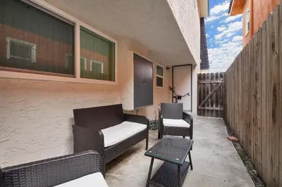 a patio with two chairs and a couch on a balcony at Walk to Shoreline Village, BBQ in Prime Location in Long Beach