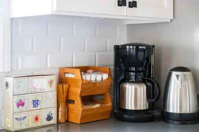 a kitchen counter with a coffee maker on a counter at Lovely Culver City Home 8 Mins to Beach Close to LAX in Los Angeles