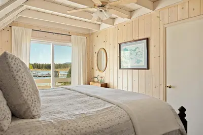 a bedroom with a bed with a ceiling fan and a window at Home Sweet Home in Big Bear Lake