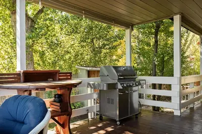 a screened in porch with a grill and a table at Home Sweet Home in Big Bear Lake