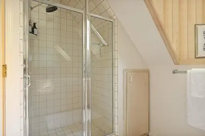 a shower with a glass door in a bathroom at Home Sweet Home in Big Bear Lake