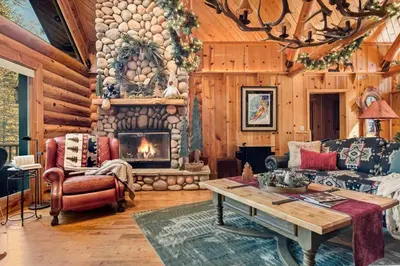 a living room with a couch and a fireplace at Honeycomb Hideaway in Big Bear Lake