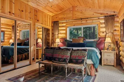 a bedroom with a bed in a log cabin at Honeycomb Hideaway in Big Bear Lake