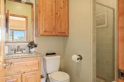a bathroom with a toilet and a sink and a shower at Hawk Ridge Chalet In Big Bear Lake in Big Bear Lake