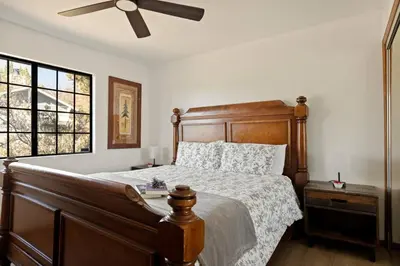 a bedroom with a bed and a ceiling fan at Solstice Shores Chalet, Hot Tub and Lake Views in Fawnskin
