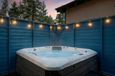 a jacuzzi tub with lights on a house at Solstice Shores Chalet, Hot Tub and Lake Views in Fawnskin