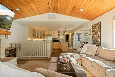 a living room with a couch and a table at Live Love Lake in Big Bear Lake