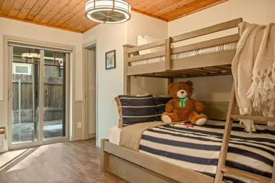 a teddy bear sitting on a bunk bed in a bedroom at Live Love Lake in Big Bear Lake