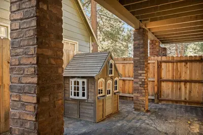 a small dog house sitting on the side of a house at Live Love Lake in Big Bear Lake