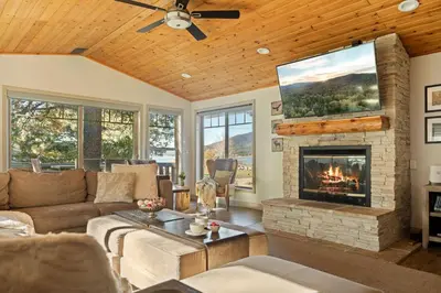 a living room with a couch and a fireplace at Live Love Lake in Big Bear Lake