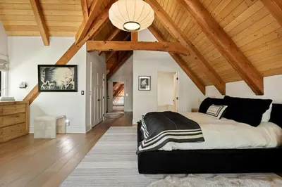 a bedroom with a large bed and wooden ceilings at Seuss by the Shore in Big Bear Lake