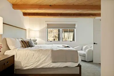 a bedroom with a large bed and a couch at Seuss by the Shore in Big Bear Lake