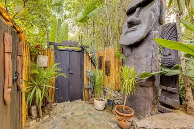 a garden with a wooden fence and a gate with plants at 2 Mi to Echo Park Funky Silver Lake Studio in Los Angeles