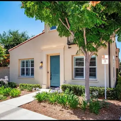 a house with a blue door and a tree at Luxury 2 Bed 2 bath Home Near Six Flags in Santa Clarita