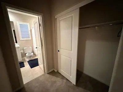 a bathroom with a white door and a toilet at Luxury 2 Bed 2 bath Home Near Six Flags in Santa Clarita