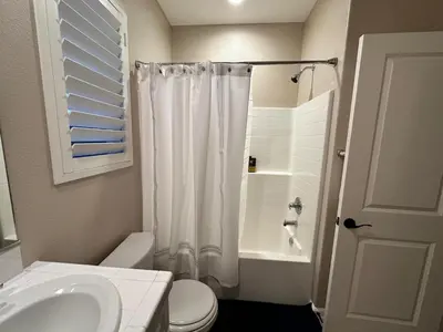 a bathroom with a toilet and a sink and a shower at Luxury 2 Bed 2 bath Home Near Six Flags in Santa Clarita