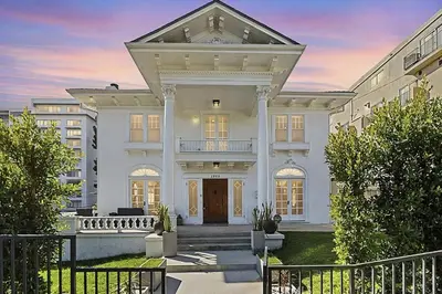 a large white house with a front yard at Hollywood Heritage Villa in Los Angeles