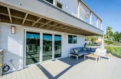 a patio with a blue couch and a table at Beautiful home with VIEWS in Silver Lake Hills in Los Angeles
