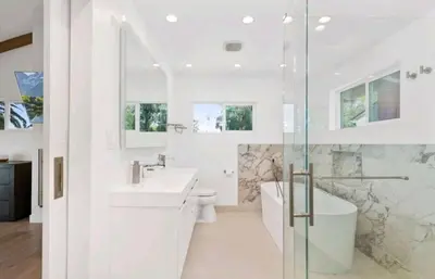 a white bathroom with a tub and a sink and a toilet at Beautiful home with VIEWS in Silver Lake Hills in Los Angeles