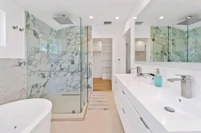 a bathroom with two sinks and a glass shower at Beautiful home with VIEWS in Silver Lake Hills in Los Angeles