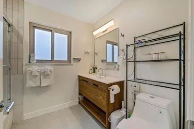 a bathroom with a toilet and a sink and a shower at 20 min to Disneyland - Spacious Family Home Near All the Fun in Westminster