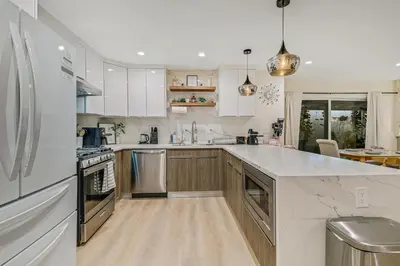 a kitchen with white cabinets and a white counter top at 20 min to Disneyland - Spacious Family Home Near All the Fun in Westminster