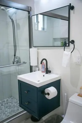 a bathroom with a sink and a shower with a mirror at 20 min to Disneyland - Spacious Family Home Near All the Fun in Westminster