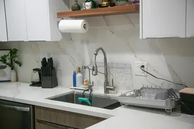 a kitchen with a sink with a faucet at 20 min to Disneyland - Spacious Family Home Near All the Fun in Westminster
