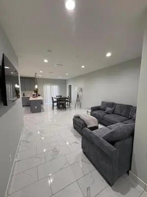 a large living room with a couch and a table at Welcome to A new updated 3 bedroom 2 Bath Home in California City