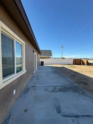 a concrete sidewalk next to a building with a window at Welcome to A new updated 3 bedroom 2 Bath Home in California City