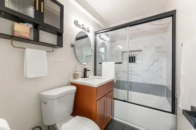 a bathroom with a toilet and a sink and a shower at Casa Verde in Inglewood