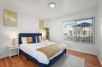 a bedroom with a bed and a window at Steps to Beach - Beach Essentials Provided! in Long Beach