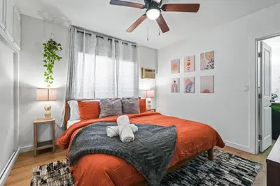 a bedroom with a bed with a teddy bear on it at Belmont Shore Getaway with Hot Tub and Firepit in Long Beach