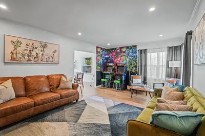 a living room with two brown couches and a living room with at Belmont Shore Getaway with Hot Tub and Firepit in Long Beach