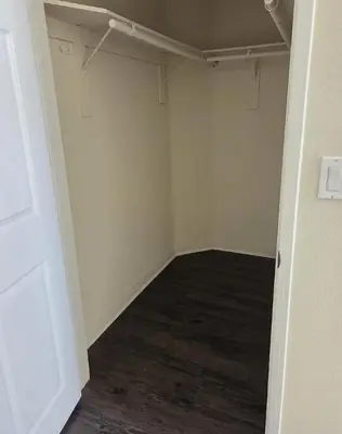an empty room with a white wall and wooden floor at Woodland Oasis 2BR With FREE PARKING in Canoga Park