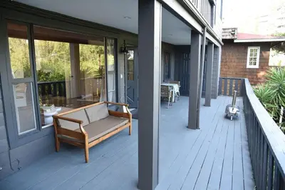 a porch with a bench on the side of a house at Hollywood Hills Duplex with view and parking! in Los Angeles
