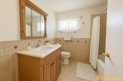 a bathroom with a sink and a toilet and a mirror at Rowland Heights Cozy & Quiet Home in Rowland Heights