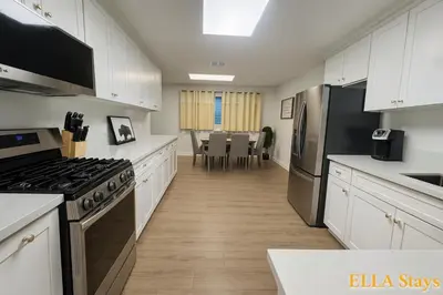 a kitchen with white cabinets and a stove top oven at Rowland Heights Cozy & Quiet Home in Rowland Heights