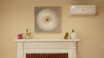 a fireplace in a living room with a picture on the wall at \u6c11\u5bbf\u963f\u5c14\u7f55\u5e03\u62c9666-888 in Alhambra