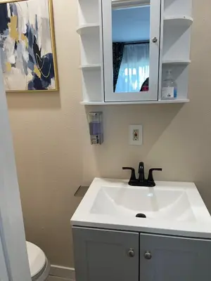 a bathroom with a white sink and a toilet at \u6c11\u5bbf\u963f\u5c14\u7f55\u5e03\u62c9666-888 in Alhambra
